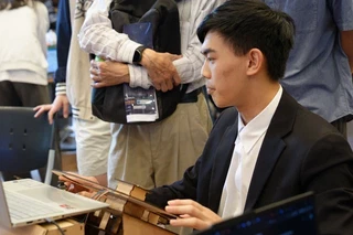 Demoing the simulator to the judges with hands on the laser-cut control rig